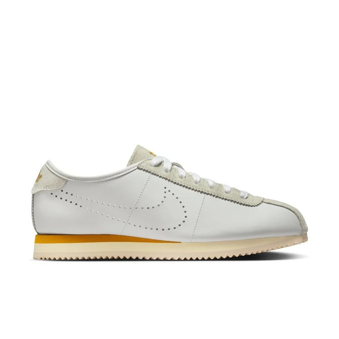 Women’s Nike Cortez-style low-top sneakers, white with bronze details and gum sole