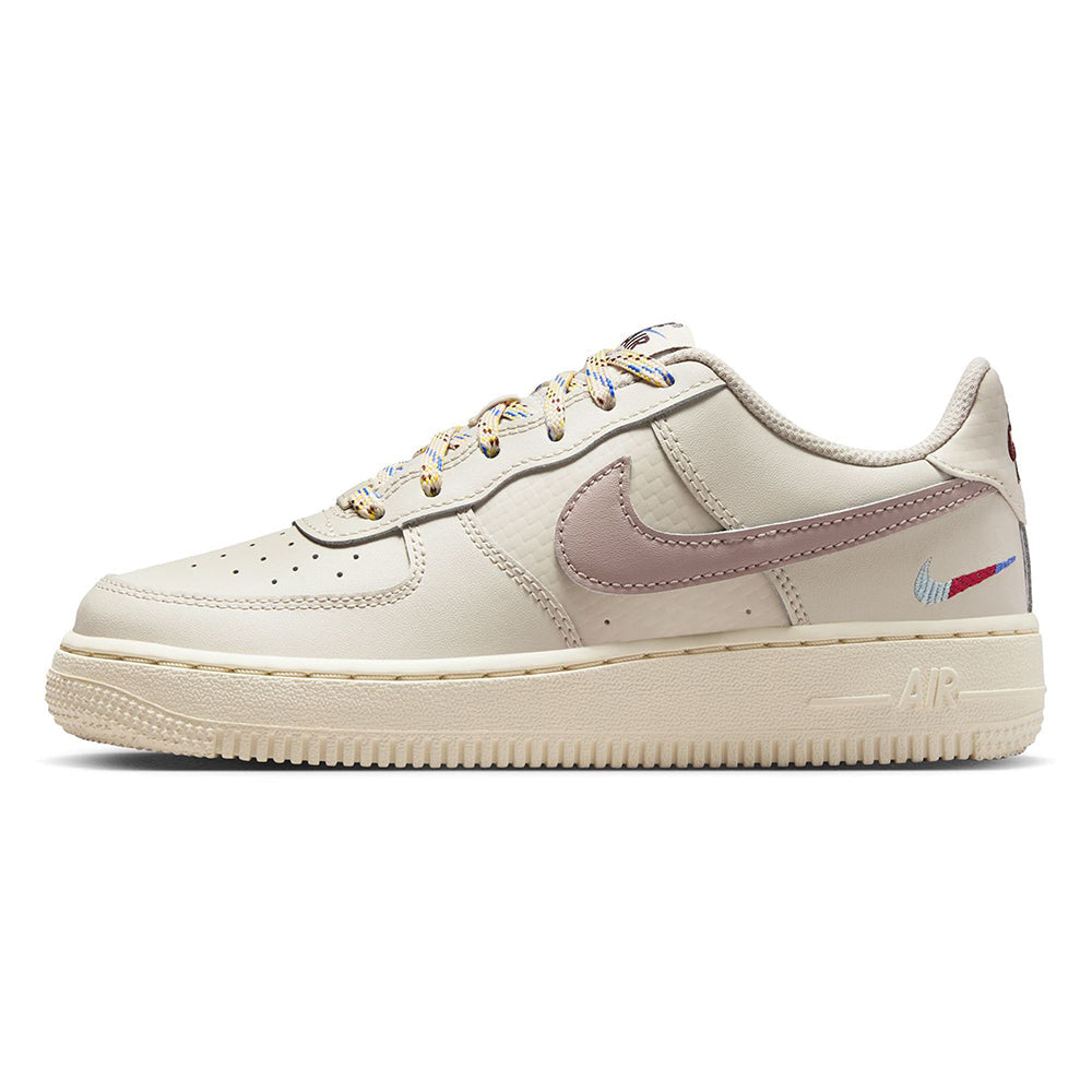 Kids' Nike Air Force 1 sneakers in off-white with mauve swoosh, perforations, and tan sole.