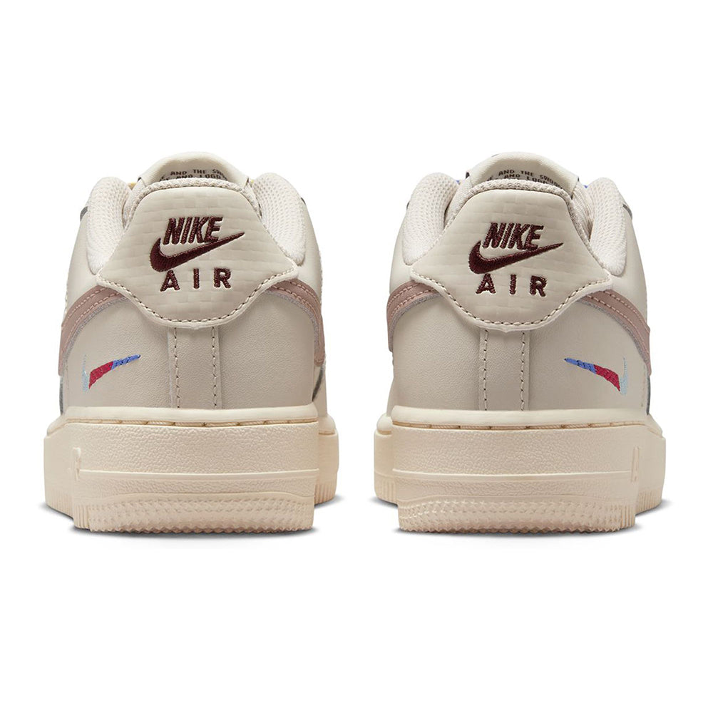 Kids' Nike Air Force 1 low-top sneakers with Nike Air heel branding in off-white.