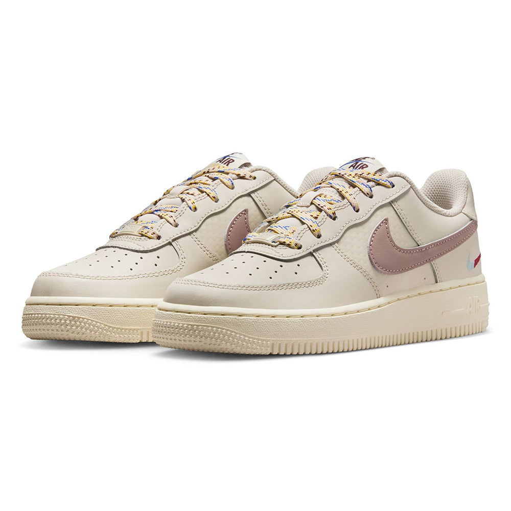 Kids' Nike Air Force 1 low-top pair in off-white with mauve swoosh and multicolor laces.