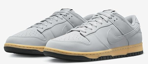 Men's Nike Dunk Low SE sneakers, pair view in light gray with gum-yellow outsole