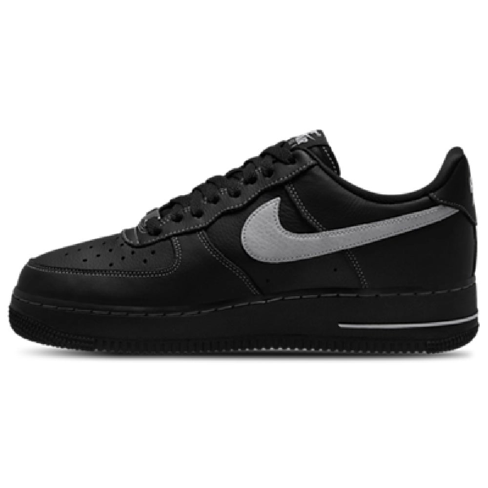 Black low-top sneaker with gray swoosh, perforated toe, and lace-up front