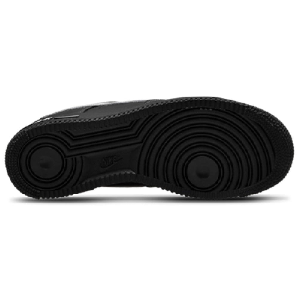 Black rubber outsole with circular tread pattern on low-top Nike sneaker