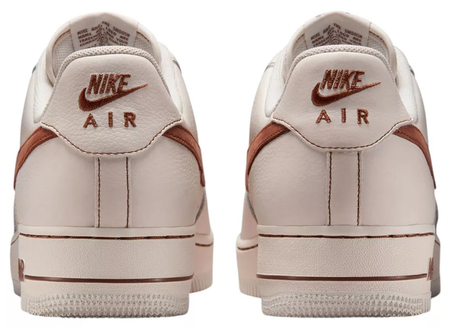 Back view of ivory Nike Air low-top sneaker with brown heel panel and Air logo