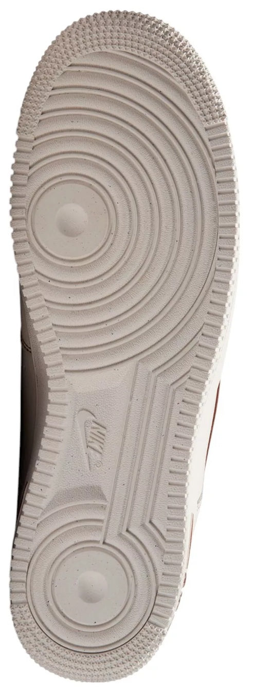 Ivory rubber outsole with circular traction pattern and Nike logo on heel