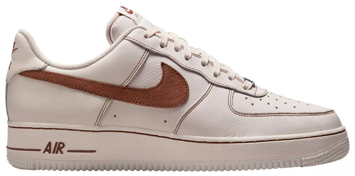 Ivory men's low-top sneaker with brown Nike Swoosh and lace-up front