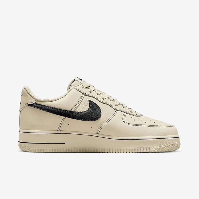 Khaki low-top sneakers with black swoosh and perforated toe; lace-up design.