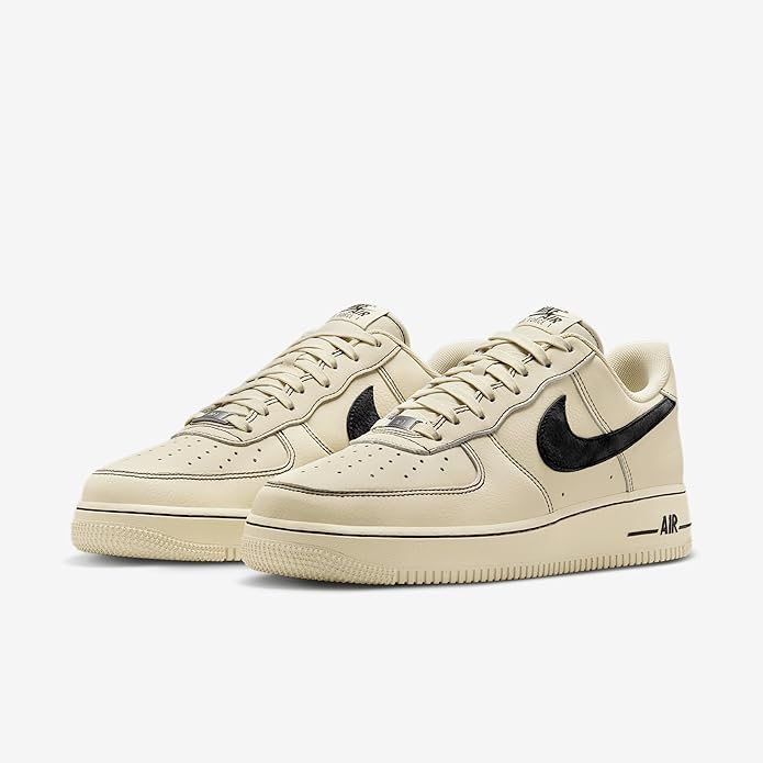 Pair of khaki low-top sneakers with black swoosh and lace-up front.