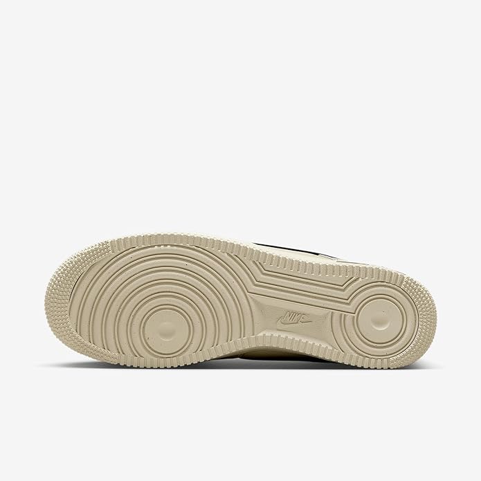 Khaki rubber outsole with circular tread pattern for Nike Air low-top sneakers.