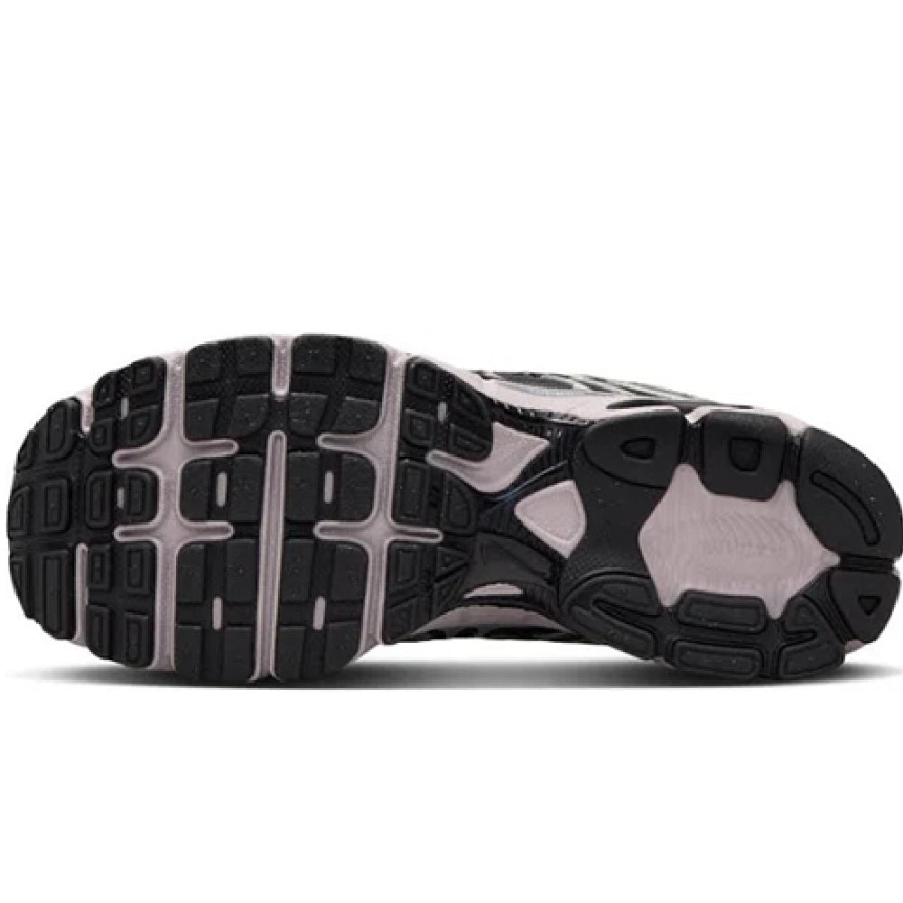 Women's Nike Air Max sneakers outsole view, black tread with gray and white panels.