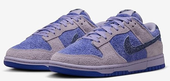 Pair of women's low-top sneakers with blue and lavender patchwork and Nike swoosh