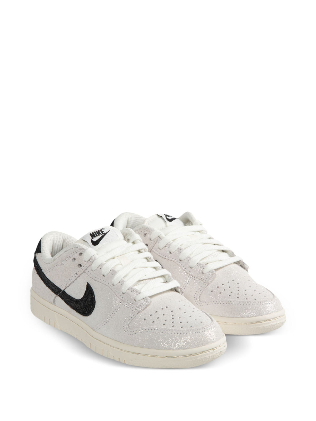 Nike Dunk Low SE sneakers, white leather upper with black Swoosh and lace-up design.