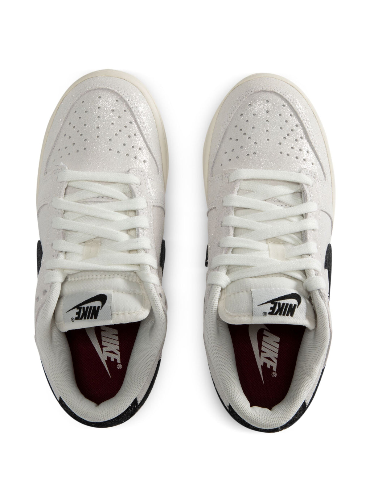 Nike Dunk Low SE sneakers, white uppers with black Swoosh and burgundy interior.