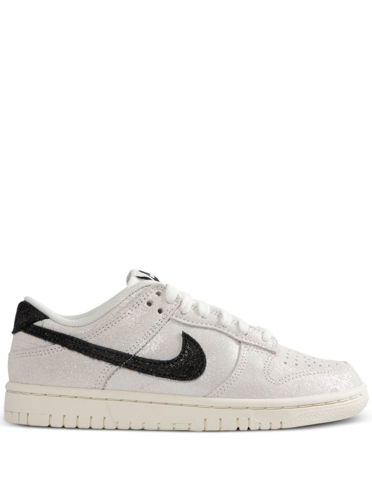 Women’s Nike low-top sneakers, white upper with black Swoosh and gum outsole.