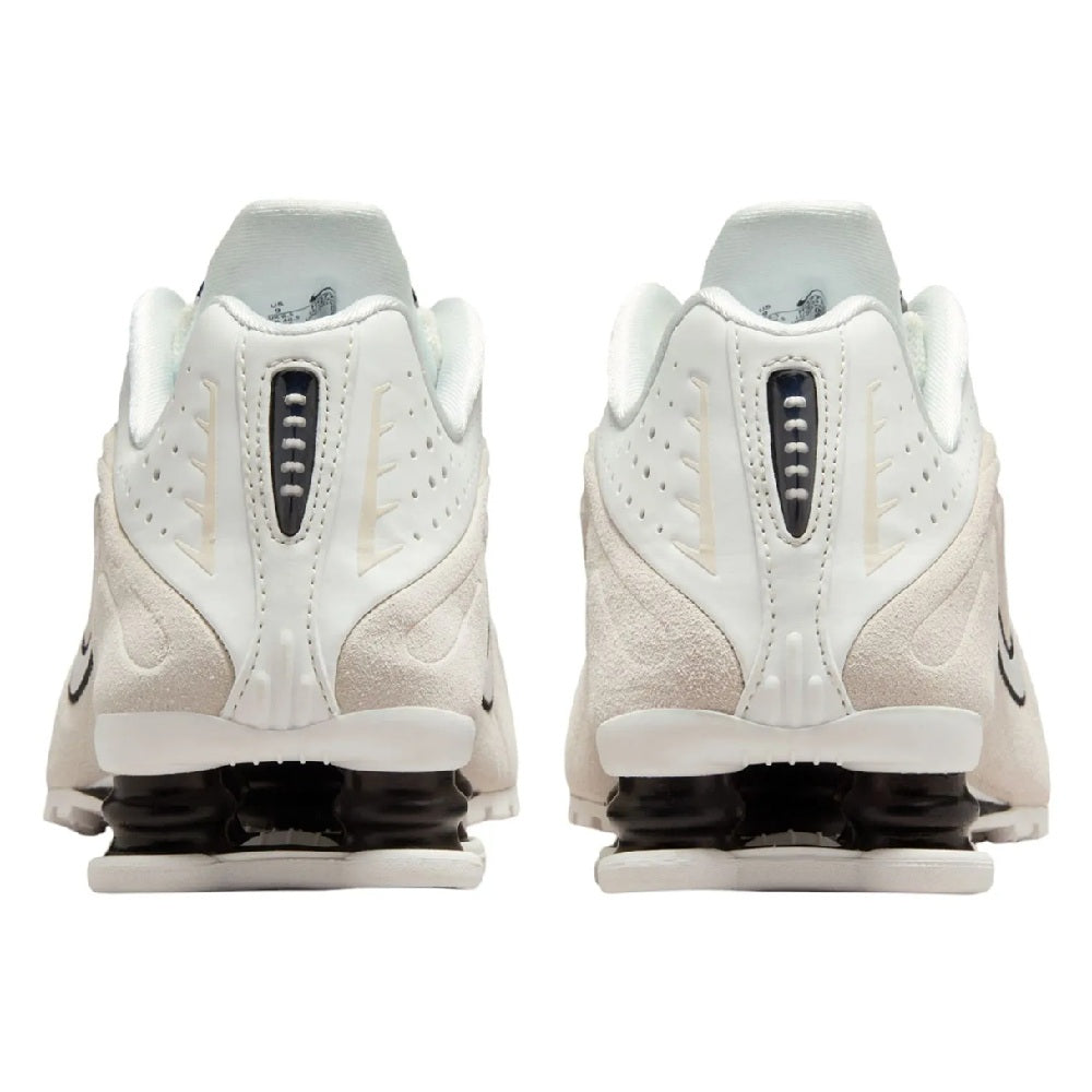 Nike Shox R4 heel view: white upper with black accents and Shox air unit