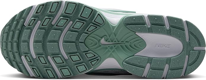Green and white rubber outsole with patterned traction for athletic sneakers