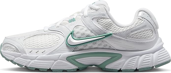 White athletic sneakers with green Nike swoosh, mesh upper, and lace-up closure