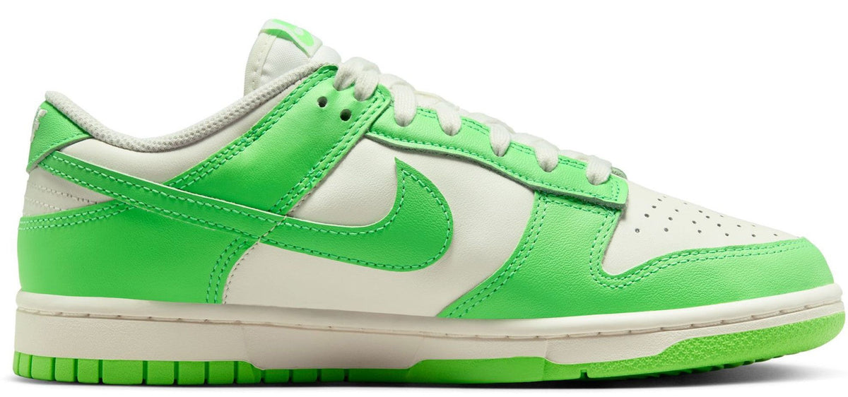 Women’s Nike Dunk Low sneakers, white and bright green uppers with lace-up and side Swoosh.
