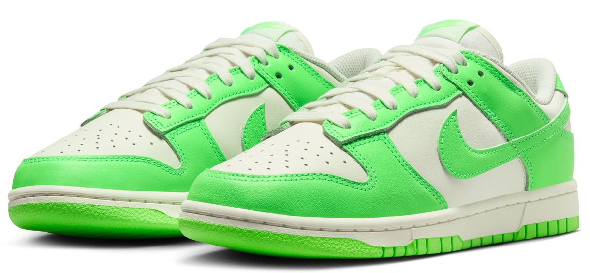 Pair of women’s Nike Dunk Low sneakers in sail white and bright green, lace-up with wing detail.