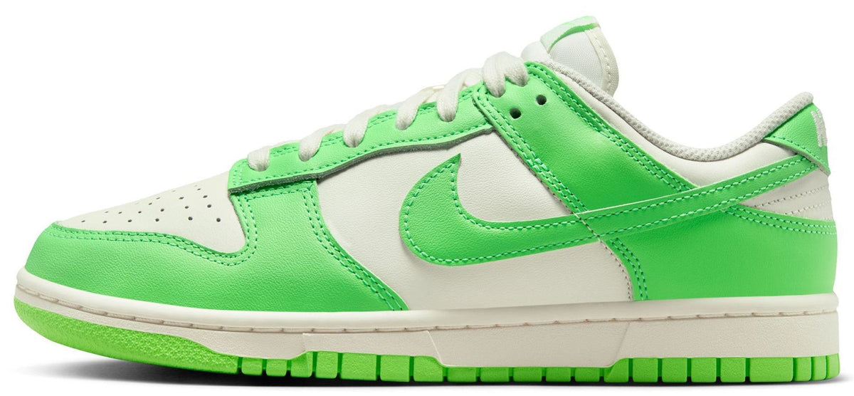 Women’s low-top Nike Dunk sneakers in sail and bright green, lace-up style, side Swoosh.