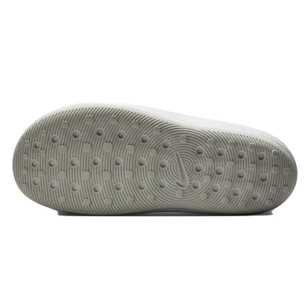 White slide sandal outsole with traction dots and swoosh emblem