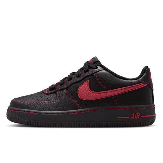 Black low-top sneakers with red Nike swoosh and 'Air' midsole detail