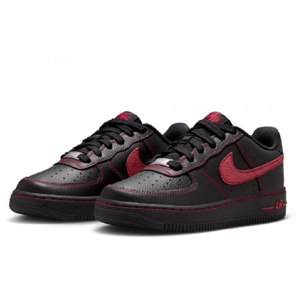Pair of black low-top sneakers with red Nike swooshes and lace-up fronts