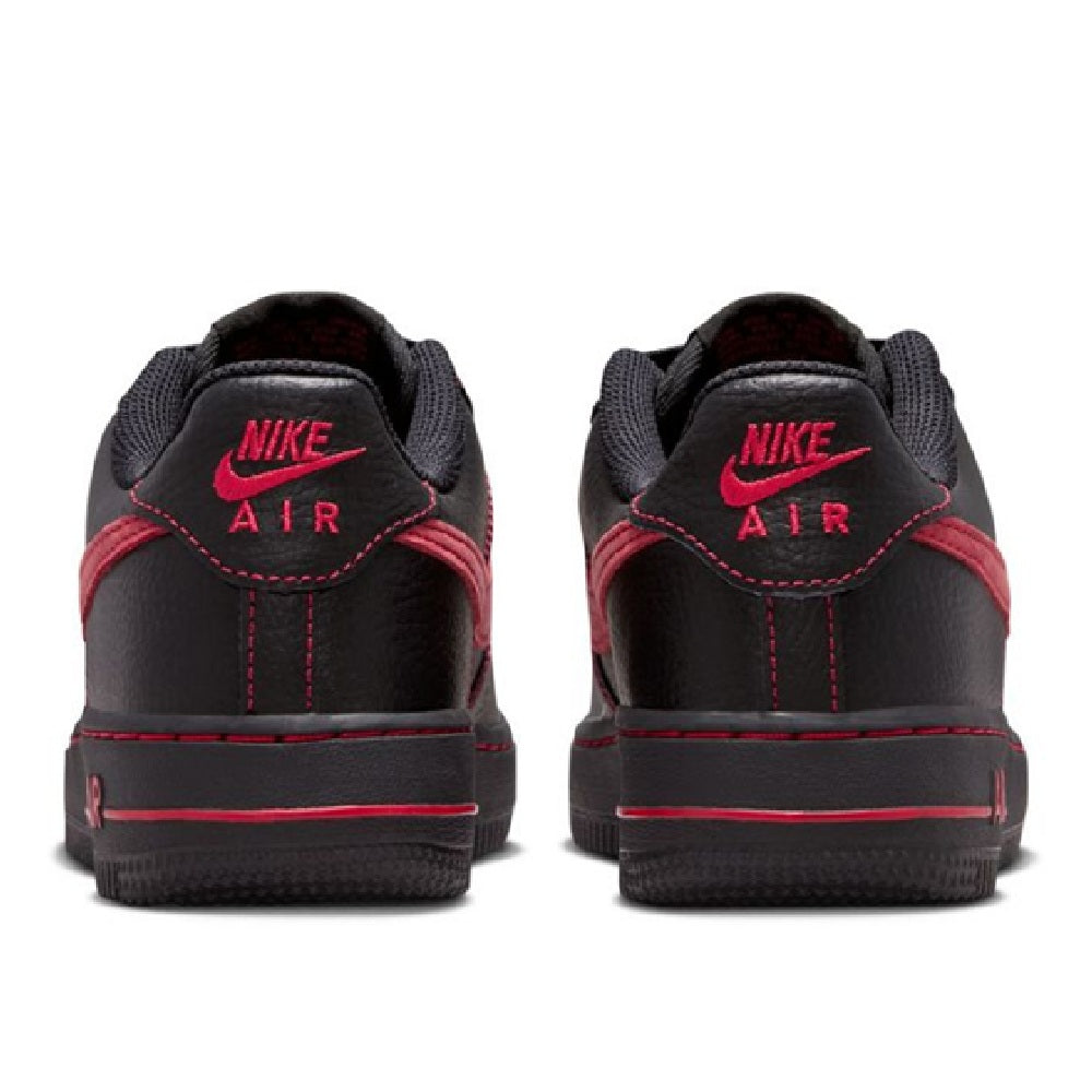 Back view of black low-top sneakers with red Nike Air heel logos