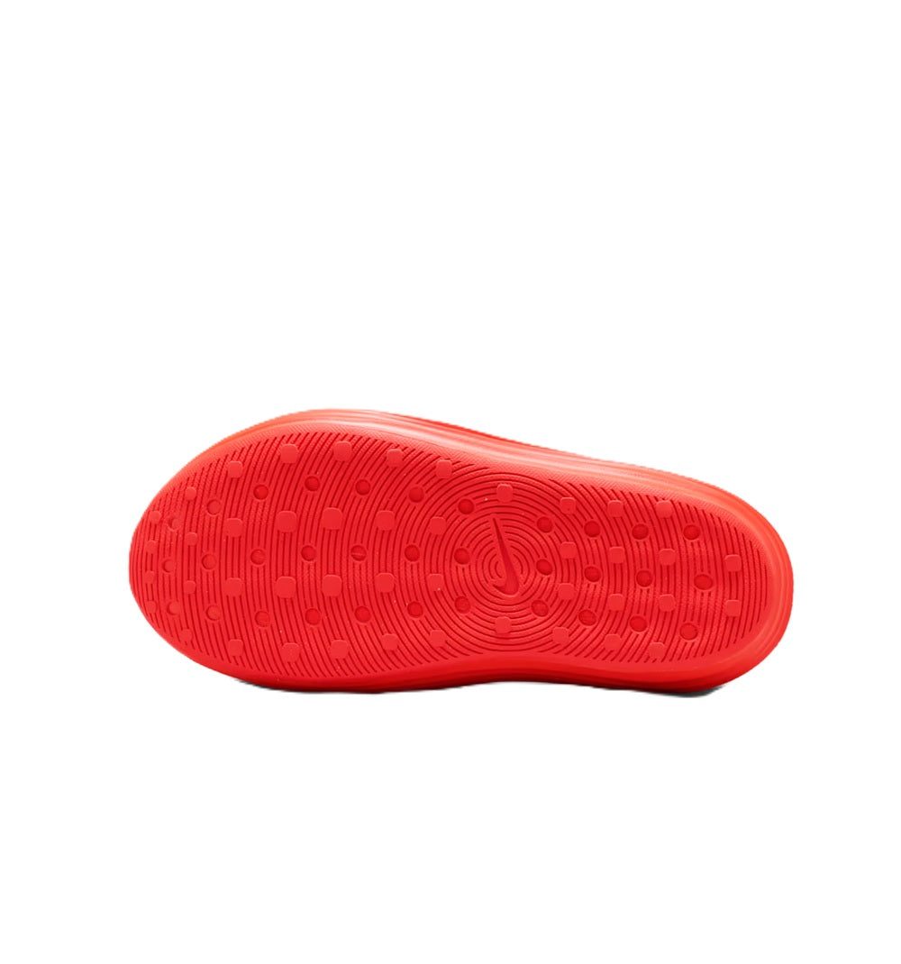 Bright red Nike slide sandal outsole with patterned grip and circular logo center