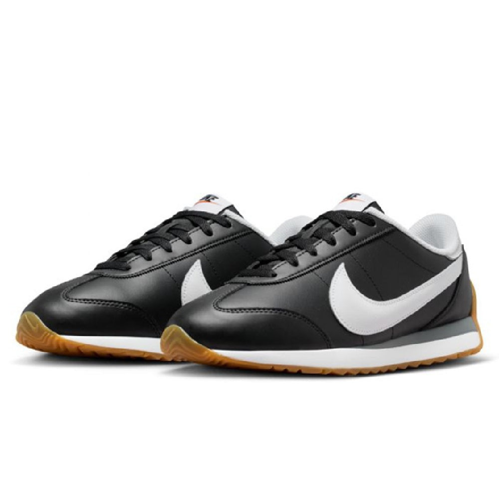 Pair of Nike low-top sneakers, black uppers with white swoosh and gum soles