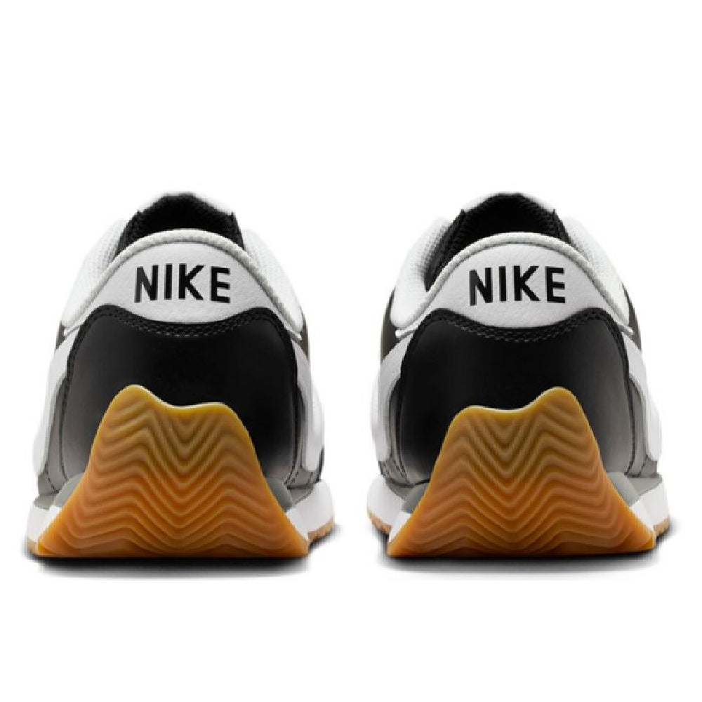 Nike low-top sneaker heel view with NIKE branding, black and white uppers, gum sole