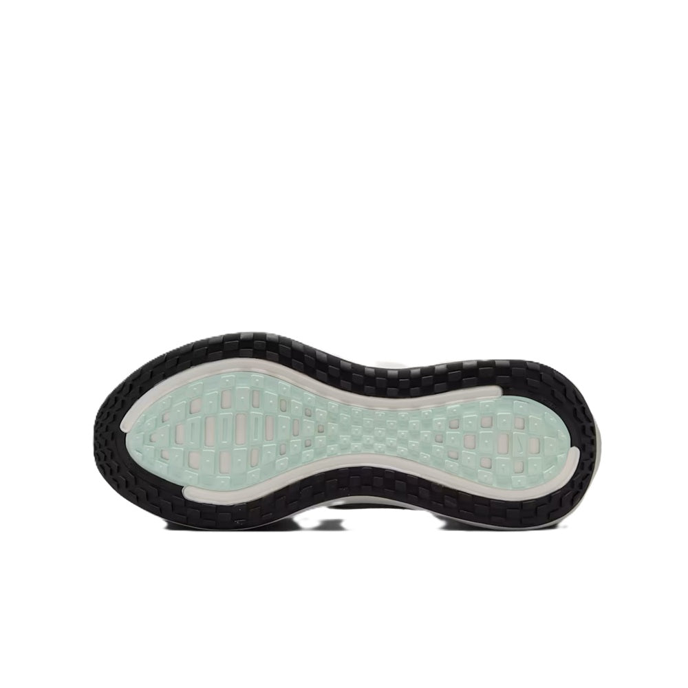 Nike Vomero Plus light silver outsole view with black traction tread pattern