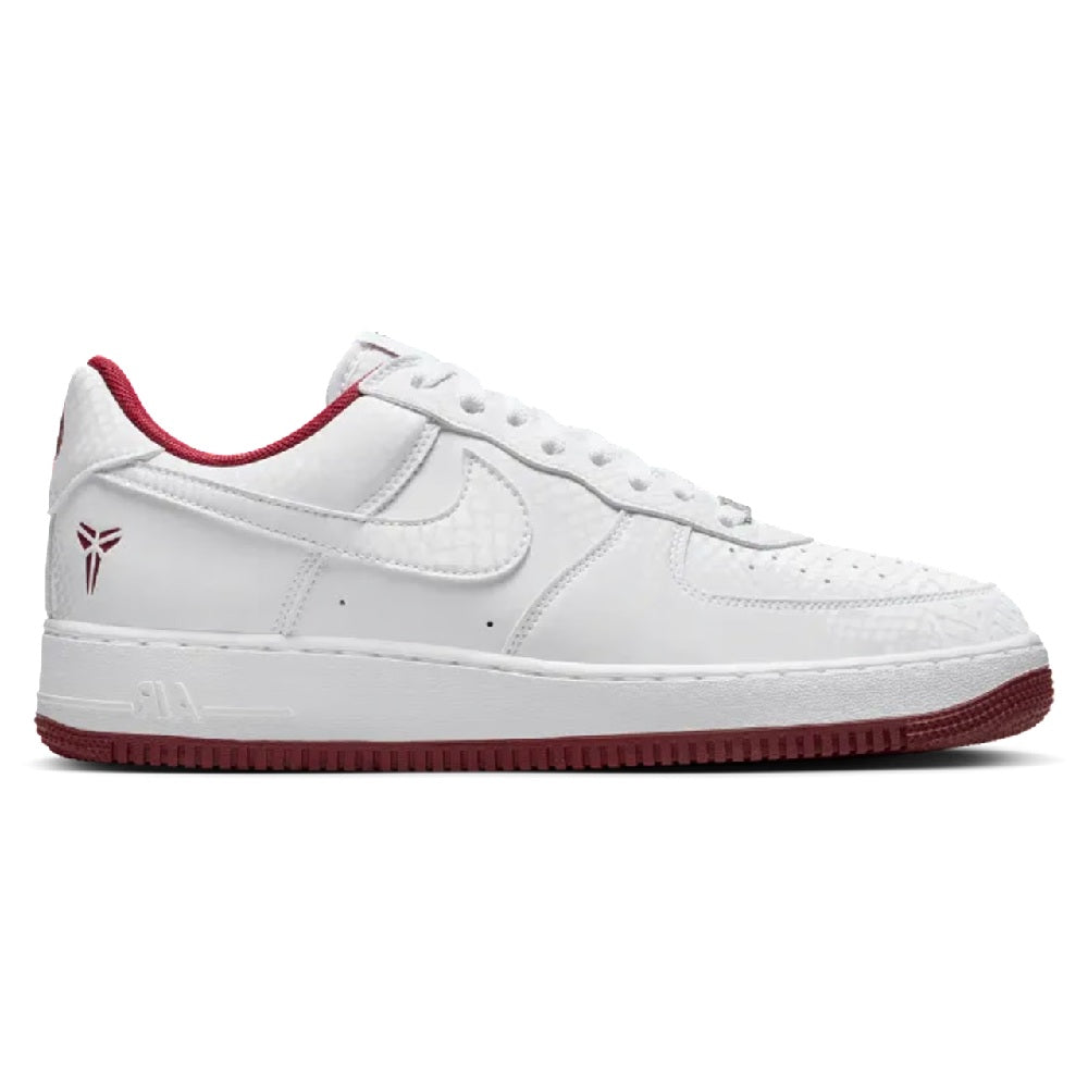 Nike Kobe low-top sneakers in white with red trim, swoosh, and side panel stitching