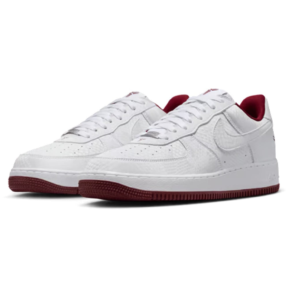 Pair of Nike Kobe low-top sneakers in white with red interior lining and lace eyelets