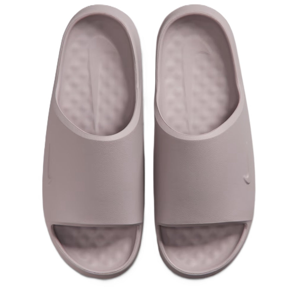 Pair of light purple Nike slide sandals with cushioned footbed and open-toe upper.