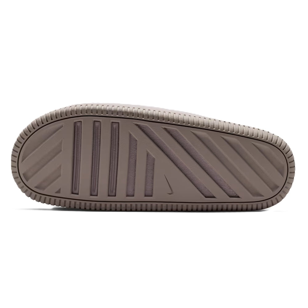 Men's Nike Calm Slide 2.0 outsole view with deep traction grooves and ridged side texture.