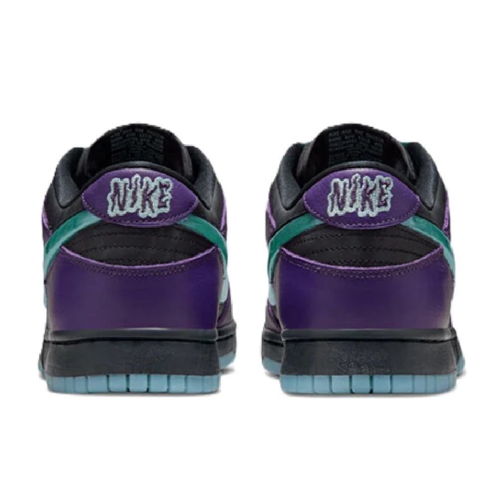 Nike low-top sneakers, rear view, purple heel with 'NIKE' logo and blue sole.