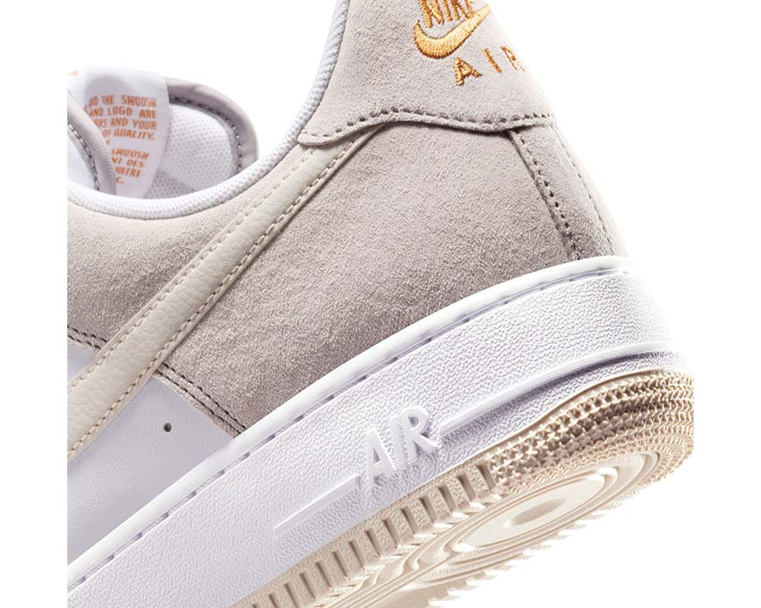 Beige suede sneaker close-up with Nike Air logo and textured gum outsole