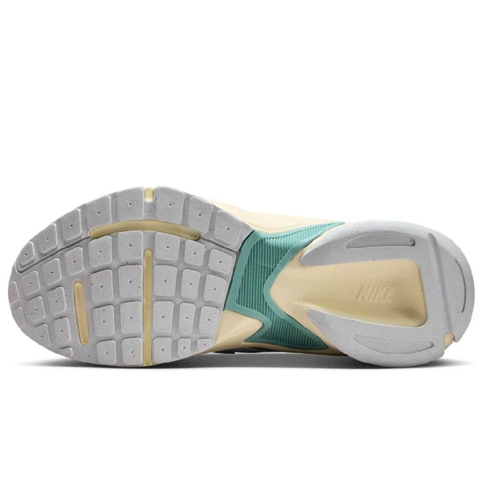 Women’s sneaker outsole view with light gray traction pads and teal midfoot panel