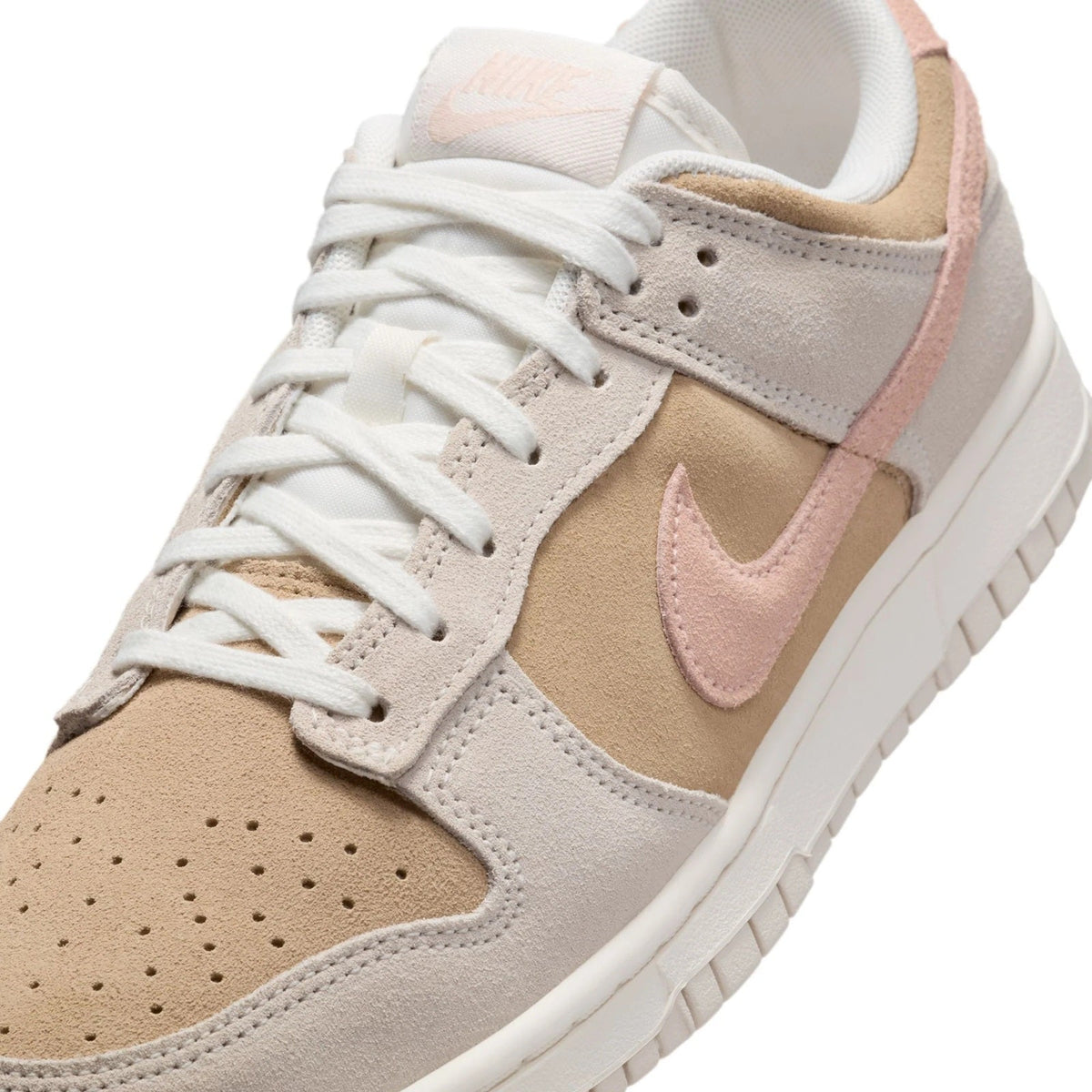 Nike Dunk Low low-top sneakers close-up of laces, swoosh, and suede panels