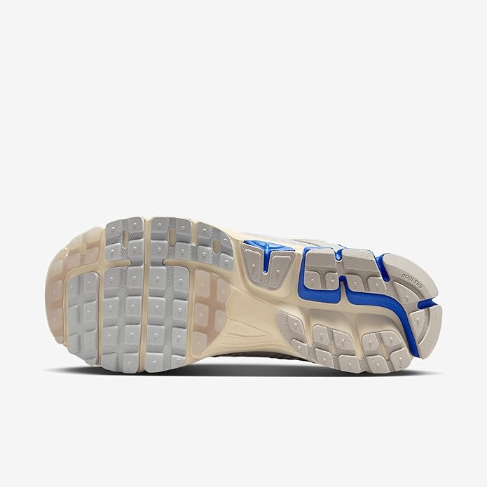 Nike Zoom Vomero 5 running sneaker outsole view, rubber tread with blue highlights