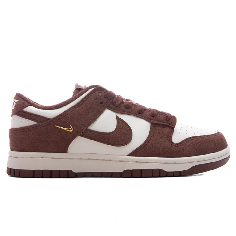 Nike Dunk Low sneakers in brown and white with gold swoosh and lace-up front