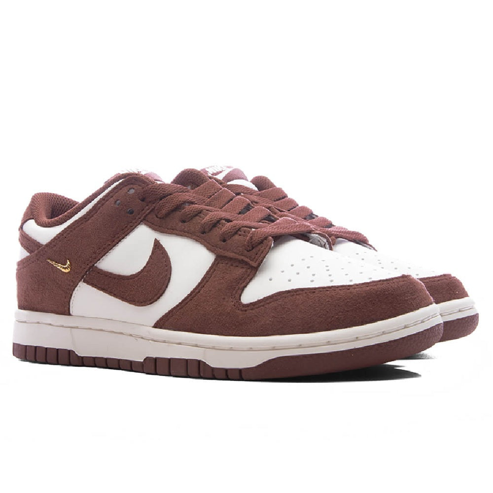 Nike Dunk Low sneakers with brown suede panels, white overlays, and lace-up top