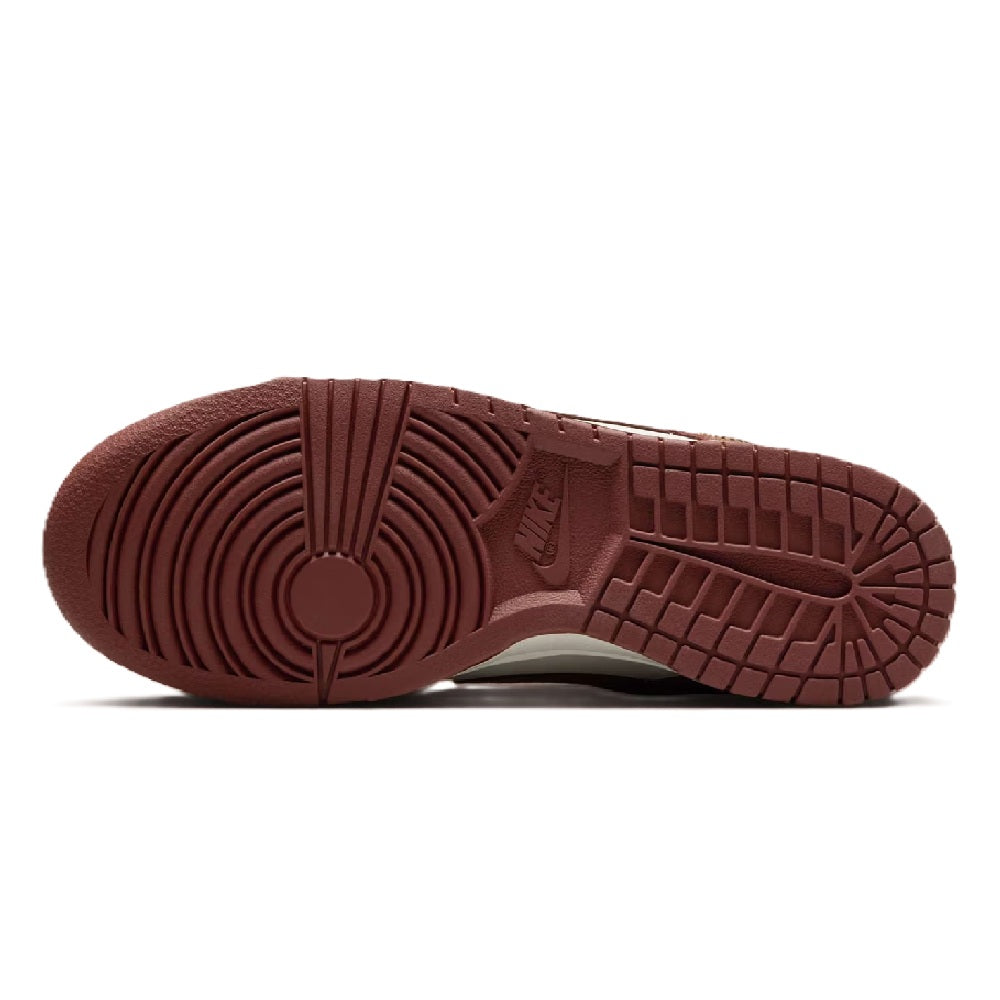 Brown rubber Nike Dunk Low outsole with circular tread pattern and grid grooves
