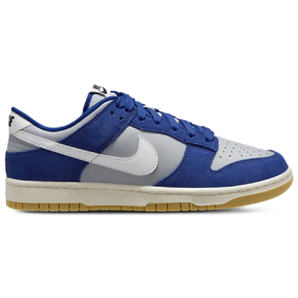 Men's low-top sneakers with blue suede panels, white overlays, and gum rubber sole