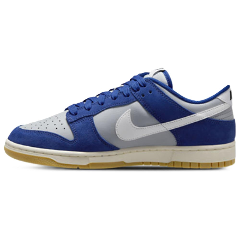 Blue and white low-top sneakers with white swoosh and gum sole