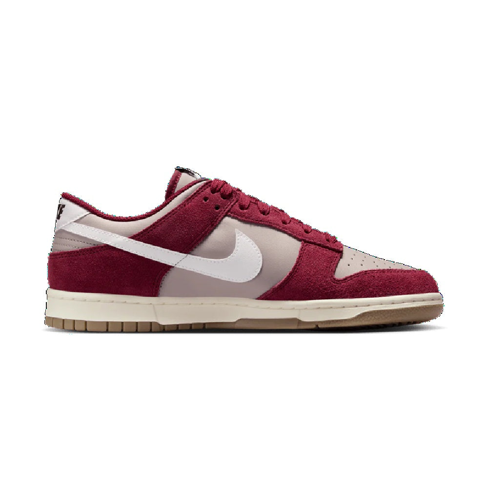 Low-top Nike sneakers in burgundy with white Swoosh and paneling, gum sole