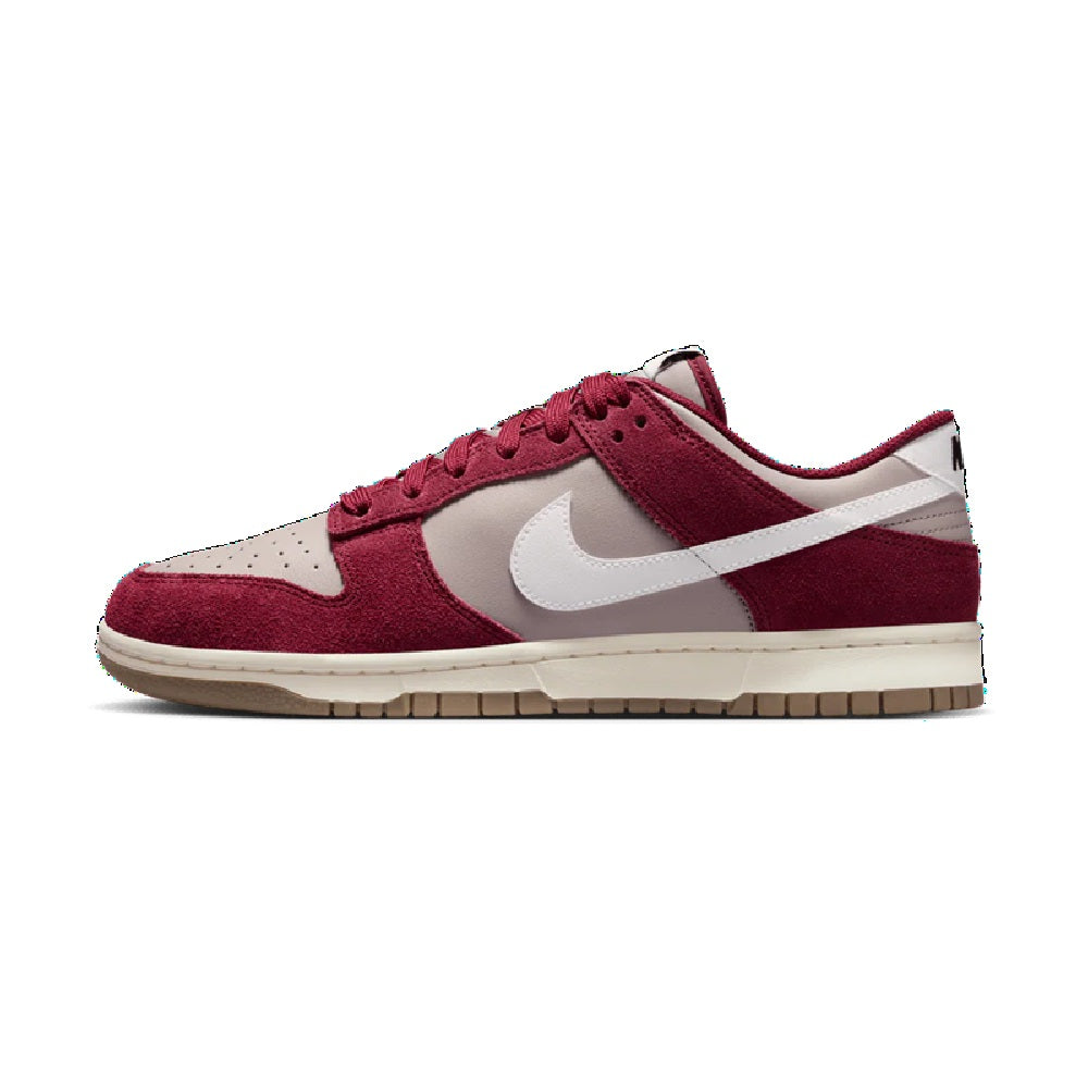 Burgundy low-top Nike sneakers with white Swoosh, lace-up design and gum outsole