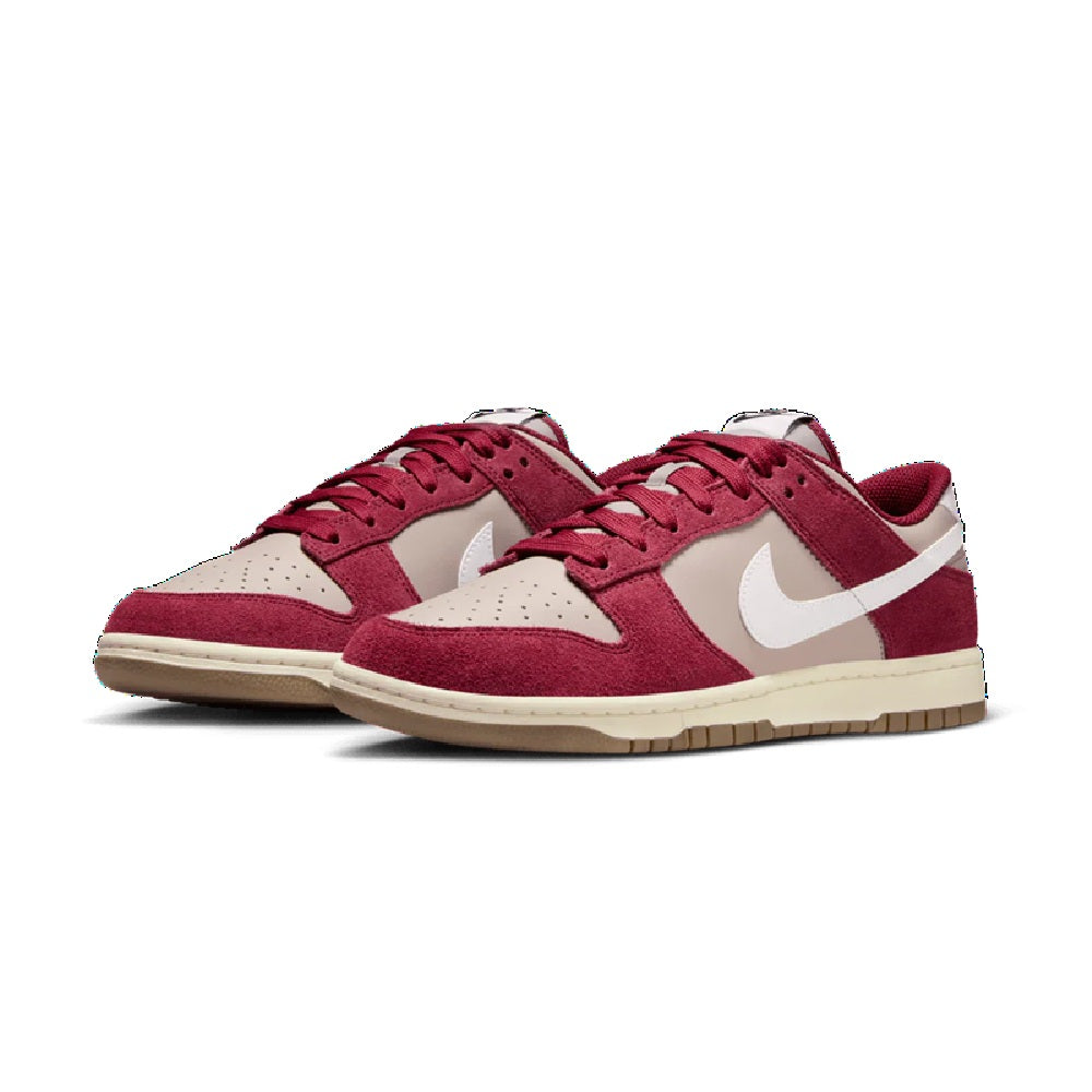 Pair of burgundy Nike low-top sneakers with white Swoosh and lace-up fronts, gum sole