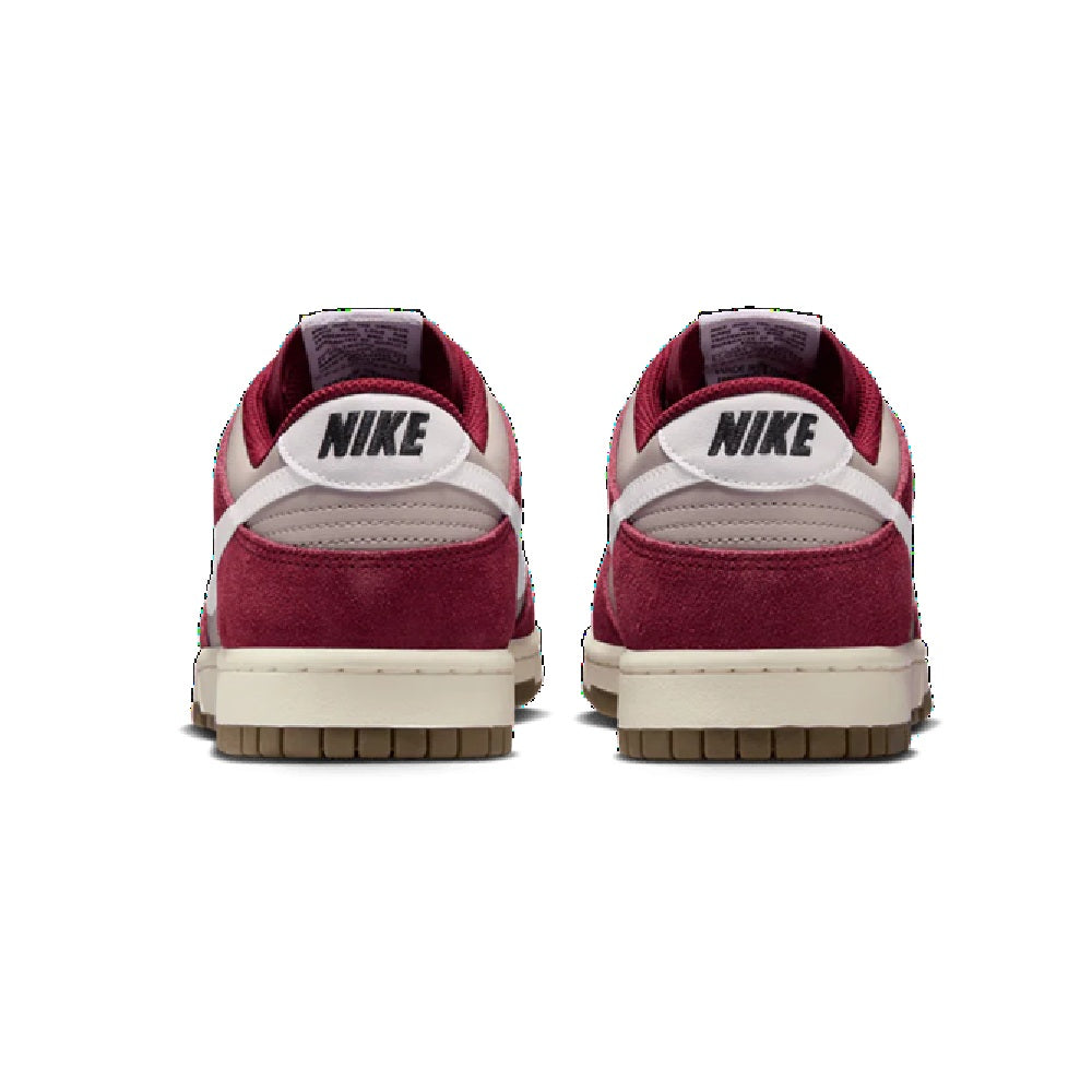 Nike low-top sneakers with burgundy heel, white collar, NIKE back branding, gum sole
